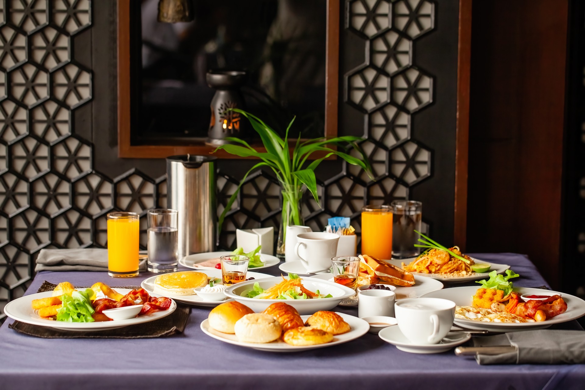 Food and drinks served on table for two persons on breakfast or brunch at morning in restaurant. Concept of weekend vacation, rest on holiday in modern city hotel. Dinner or lunch in cafe in resort